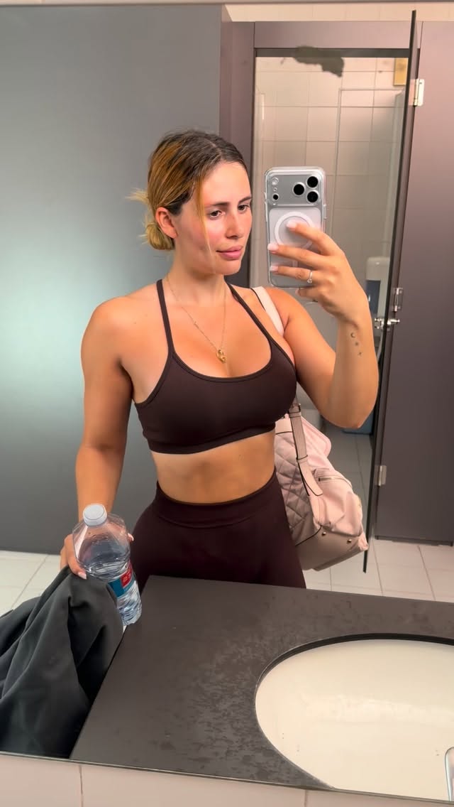 Selfie de espejo en el gimnasio con top marrón